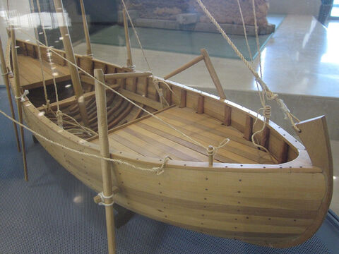 This model of the boat shows you what it would have looked like. The boat was constructed primarily of cedar planks joined together by pegged mortice and tennon joints. It has a shallow draft with a flat bottom, allowing it to get very close to the shore. – Slide 12