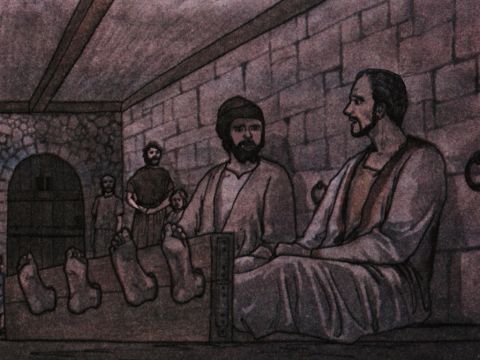 When he received these orders, he put them in the inner cell and fastened their feet in the stocks. <br/>About midnight Paul and Silas were praying and singing hymns to God, and the other prisoners were listening to them. – Slide 6